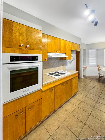 a kitchen with stainless steel appliances a stove sink and cabinets