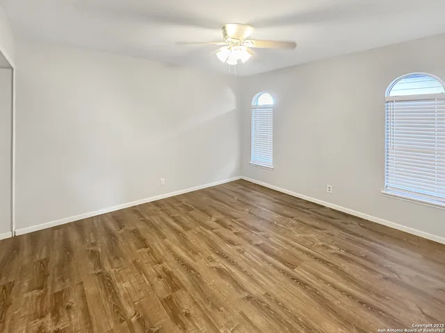 wooden floor in an empty room with a window