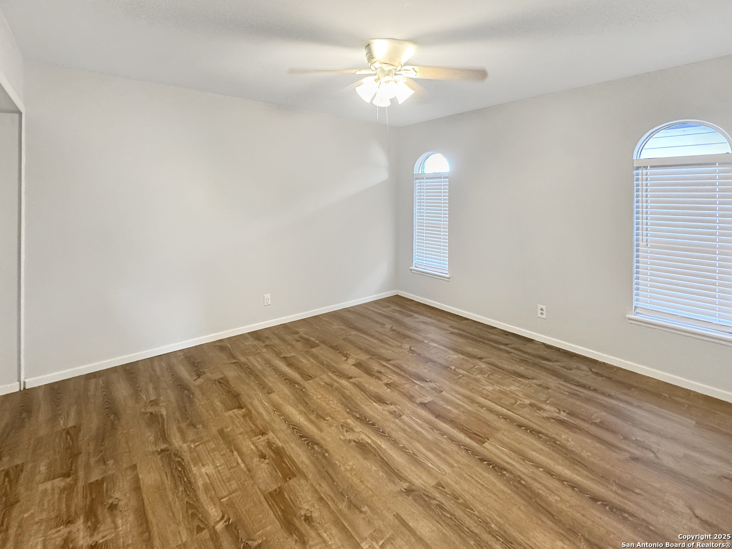 10806 Mount Tipton San Antonio, TX 78213 - Photo 17 of 22 wooden floor in an empty room with a window