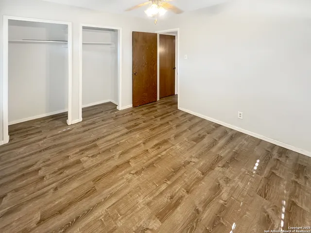 an empty room with wooden floor and closet