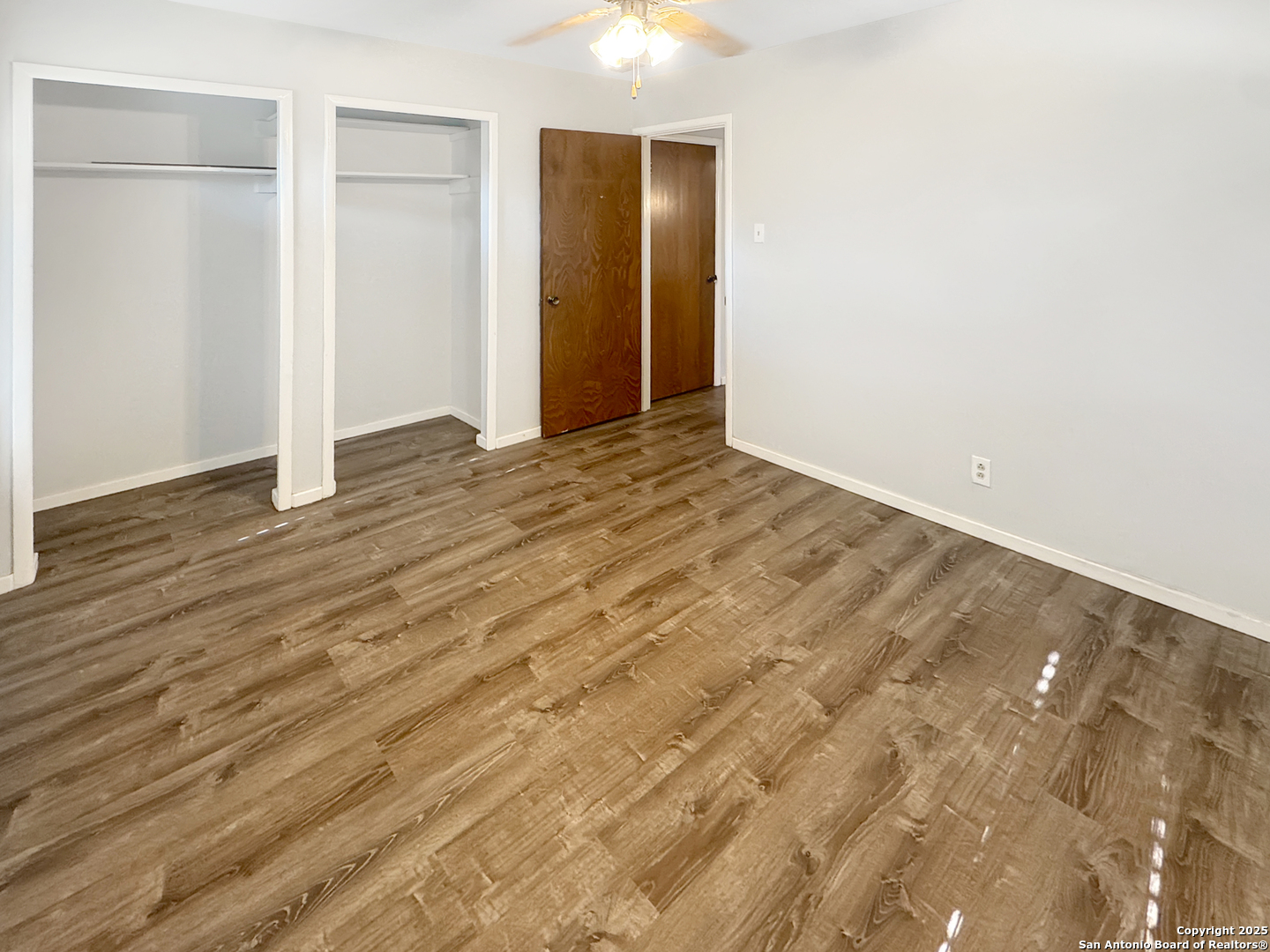 10806 Mount Tipton San Antonio, TX 78213 - Photo 19 of 22 an empty room with wooden floor and closet