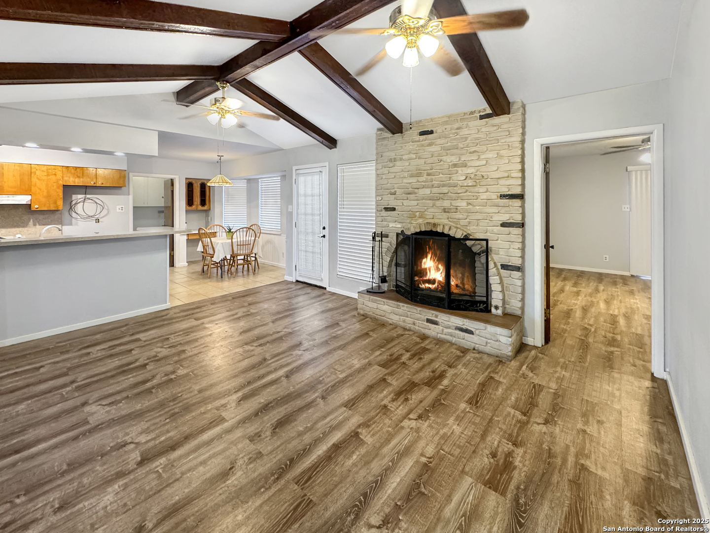 10806 Mount Tipton San Antonio, TX 78213 - Photo 2 of 22 an empty room with wooden floor fireplace and windows