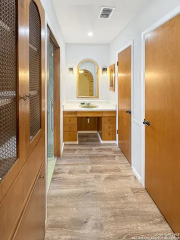 a spacious bathroom with a sink and a mirror
