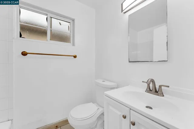 a bathroom with a sink a toilet and mirror