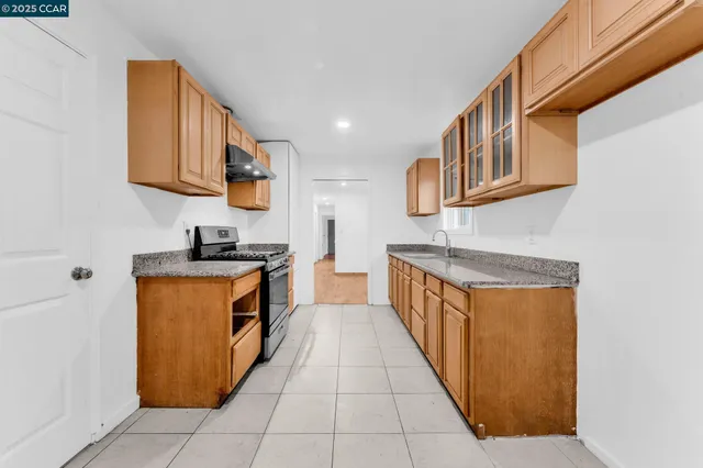 a kitchen with stainless steel appliances granite countertop a sink and cabinets