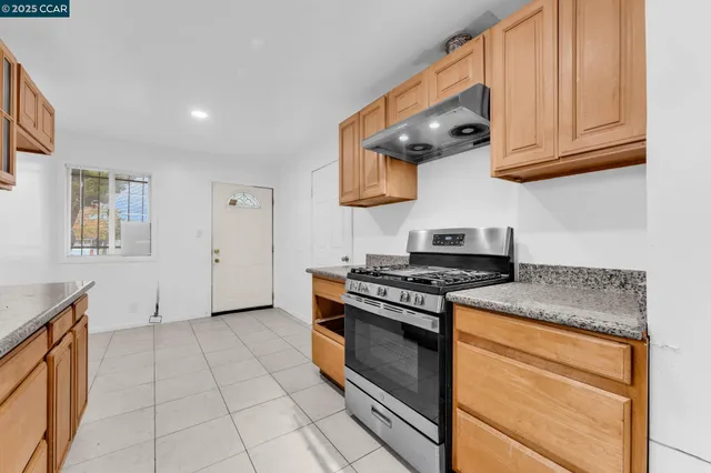 a kitchen with stainless steel appliances granite countertop a stove and a sink