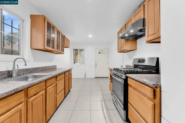 a kitchen with stainless steel appliances granite countertop a stove and a sink