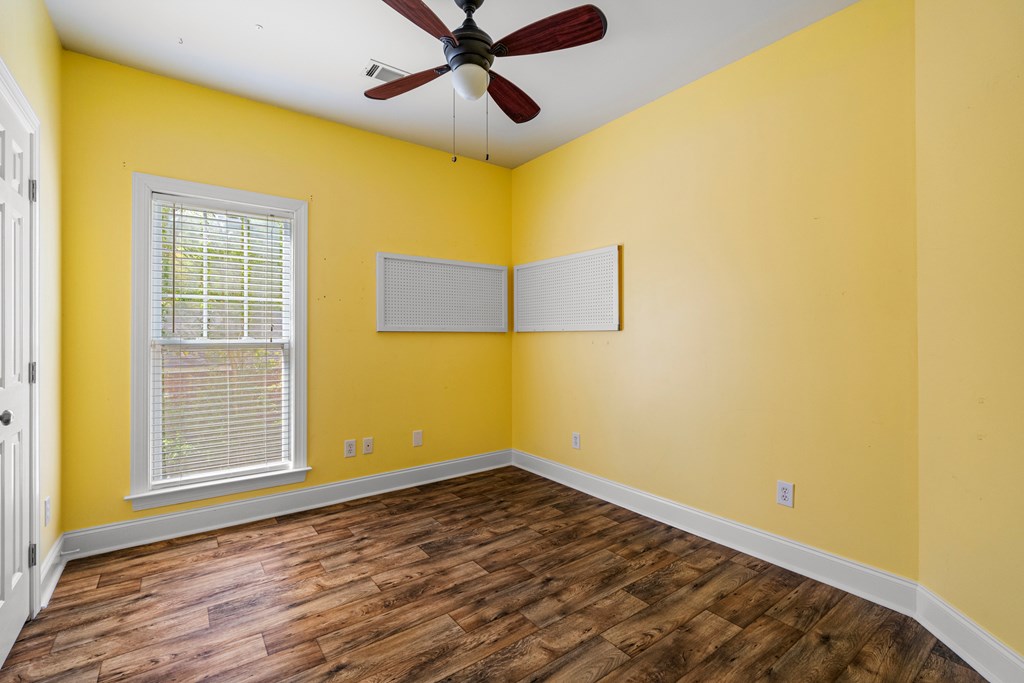 7031 Mellwood Road Columbus, GA 31904 - Photo 7 of 15 a view of an empty room with wooden floor and a window