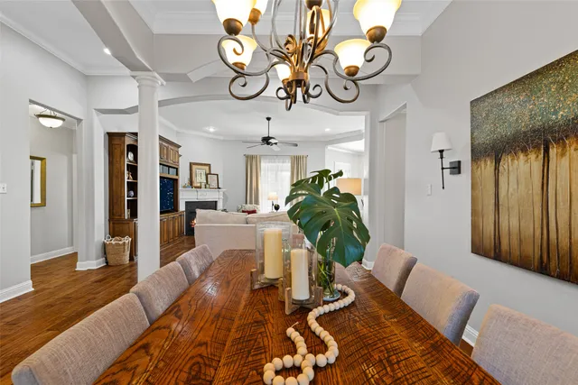 a living room with furniture a dining table and a chandelier