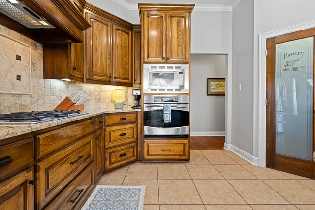 a kitchen with stainless steel appliances a stove sink and cabinets