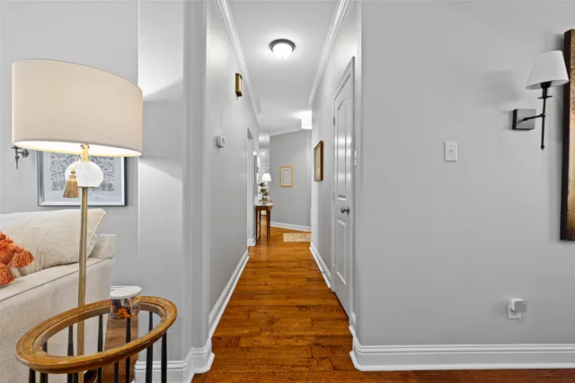 a view of a hallway with a livingroom and furniture