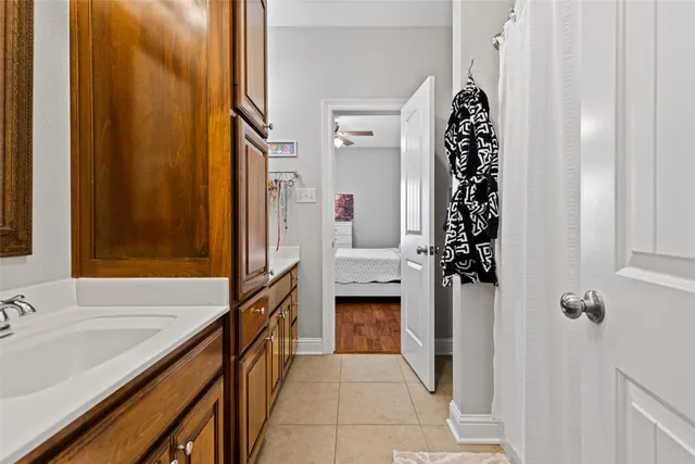 a hallway with sink and cabinets