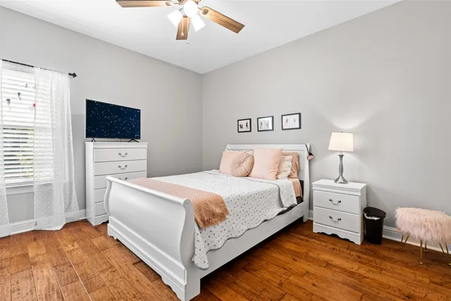 a bedroom with a bed and a flat screen tv