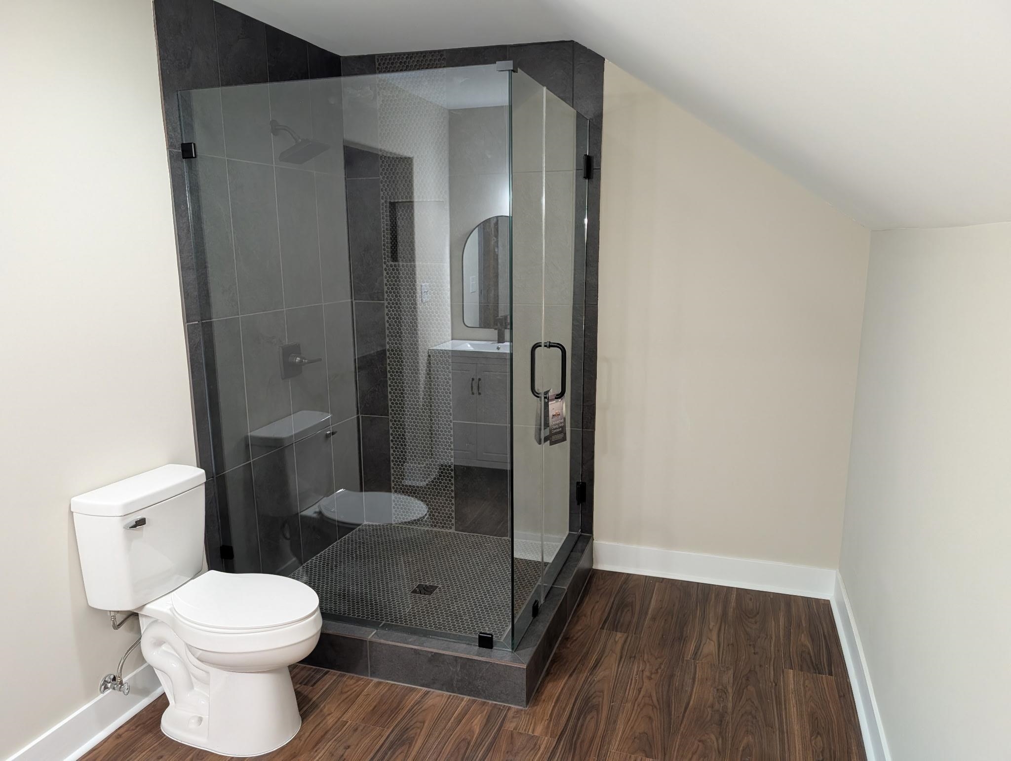 3540 Portersville Road Atoka, TN 38004 - Photo 28 of 37 Enclosed glass shower with dark tile surround and dark hexagonal floor tile