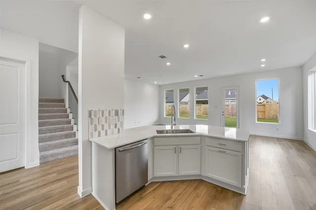 a kitchen with a sink and cabinets