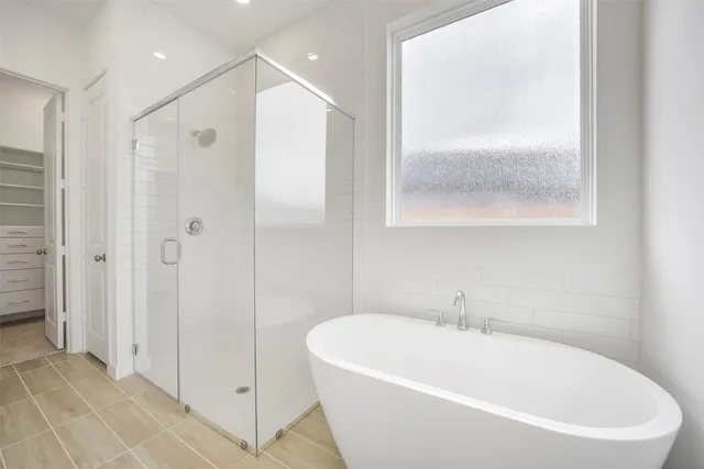 a white bath tub sitting next to a shower