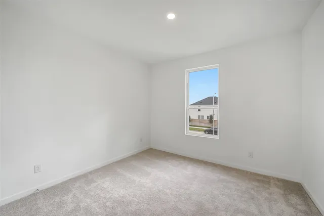 a view of an empty room and a window