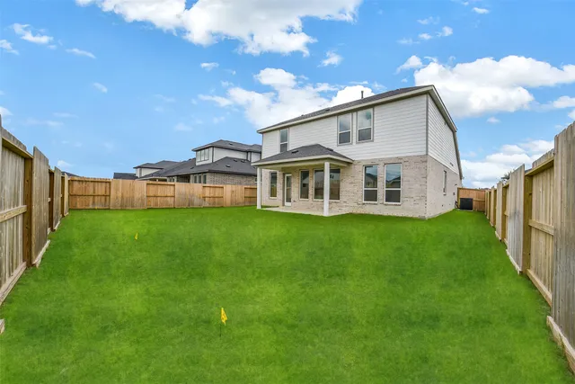 a view of a house with a backyard