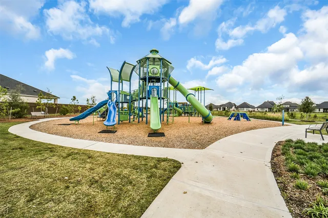 a view of a park with swings and slides