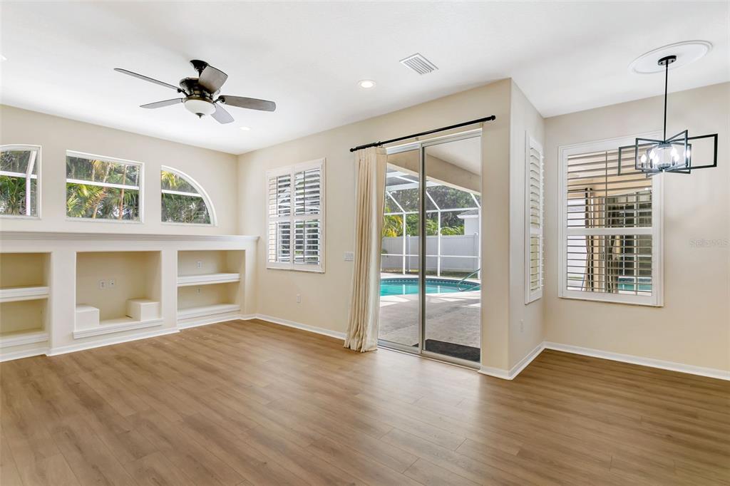 11209 Pine Lilly Place Lakewood Ranch, FL 34202 - Photo 13 of 26 a view of an empty room with a window and wooden floor