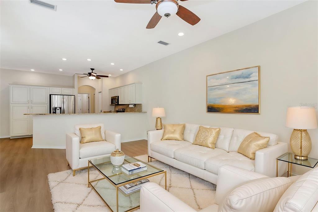 11209 Pine Lilly Place Lakewood Ranch, FL 34202 - Photo 14 of 26 a living room with furniture and a view of kitchen