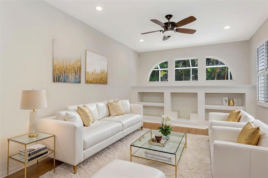 11209 Pine Lilly Place Lakewood Ranch, FL 34202 - Photo 15 of 26 a living room with furniture and a ceiling fan