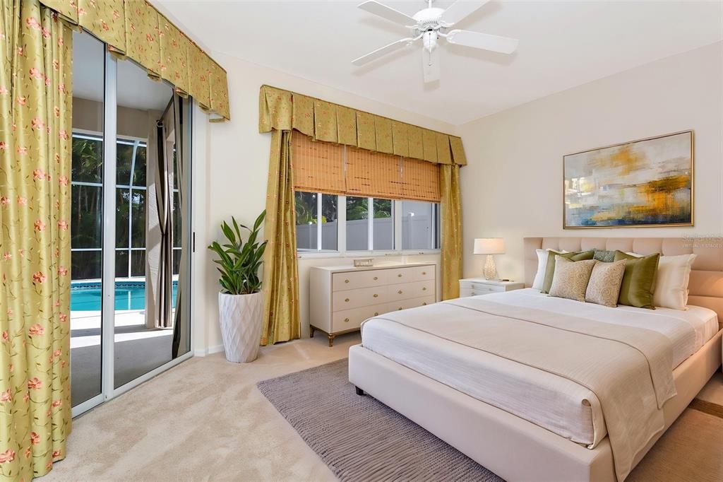 11209 Pine Lilly Place Lakewood Ranch, FL 34202 - Photo 16 of 26 a bedroom with a large bed and a large window