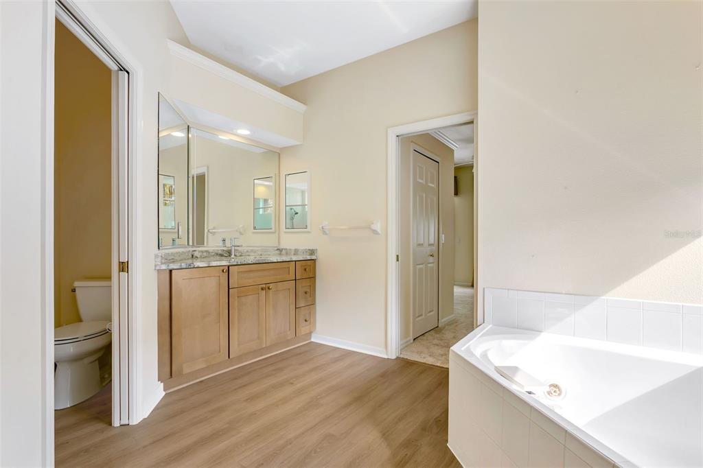 11209 Pine Lilly Place Lakewood Ranch, FL 34202 - Photo 18 of 26 a bathroom with a sink a toilet and shower
