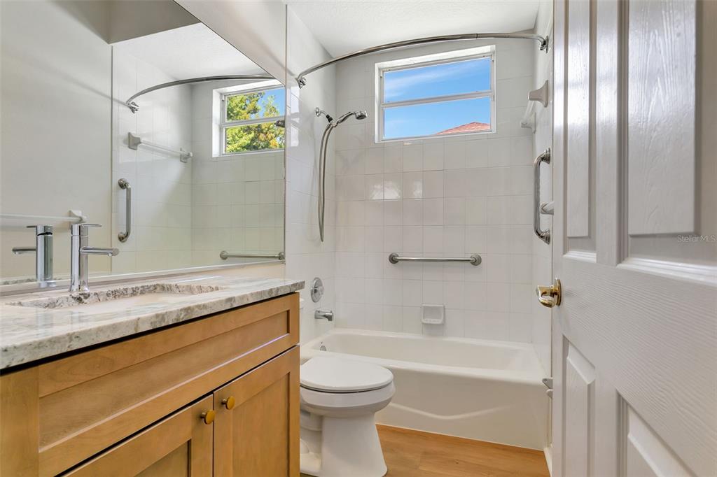 11209 Pine Lilly Place Lakewood Ranch, FL 34202 - Photo 22 of 26 a bathroom with a granite countertop sink toilet and shower