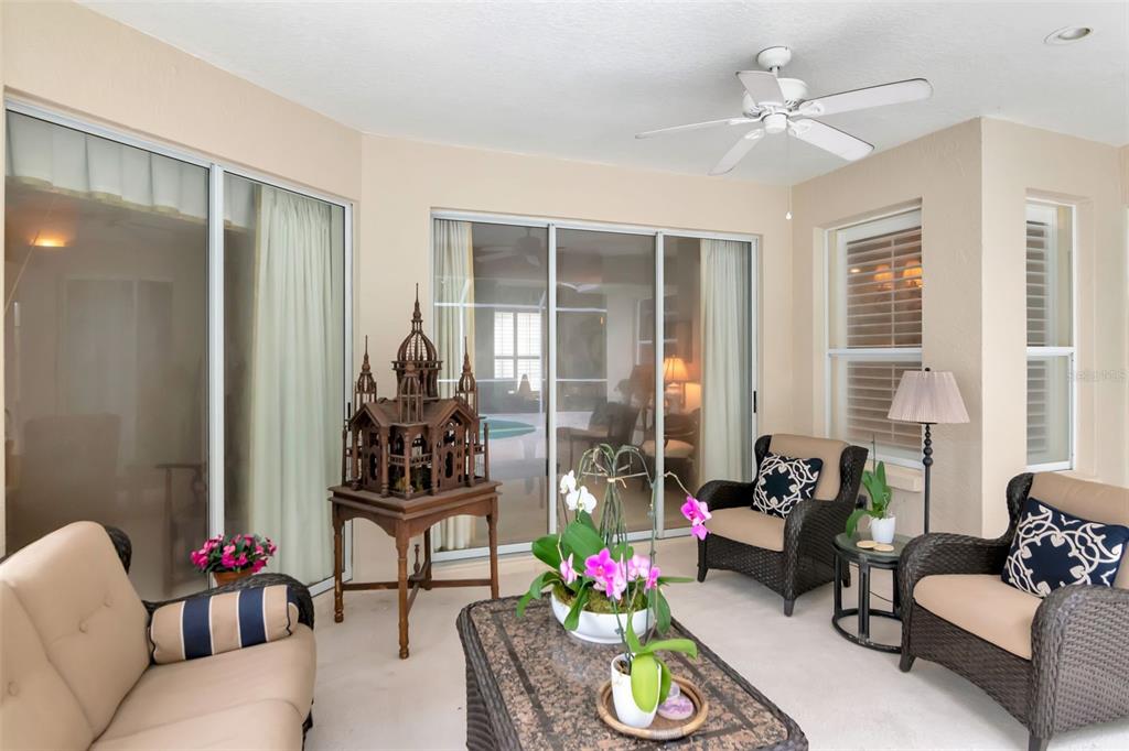 11209 Pine Lilly Place Lakewood Ranch, FL 34202 - Photo 24 of 26 a living room with furniture and wooden floor