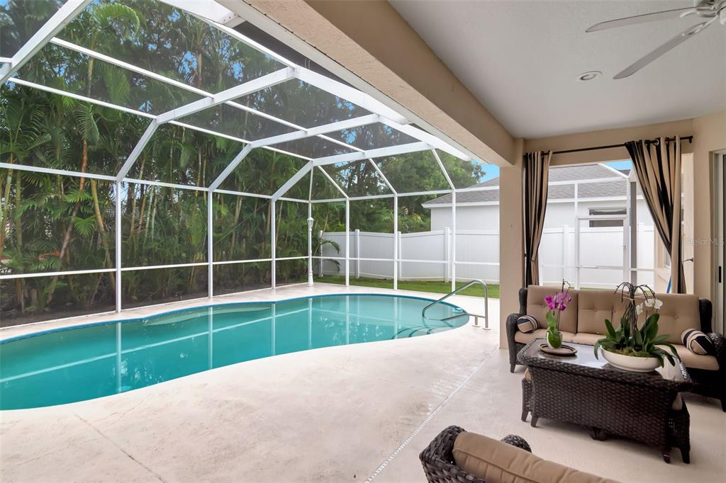 11209 Pine Lilly Place Lakewood Ranch, FL 34202 - Photo 25 of 26 a view of a room with a large window and wooden floor