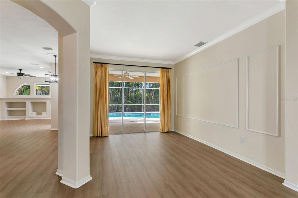 11209 Pine Lilly Place Lakewood Ranch, FL 34202 - Photo 5 of 26 a view of an empty room with wooden floor and a window
