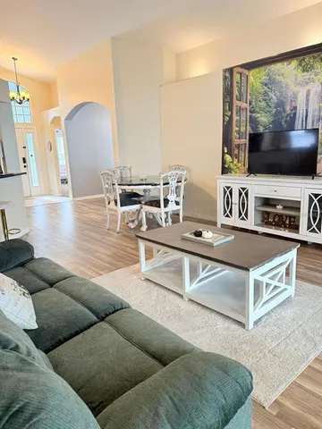 a bathroom with a window and a chair