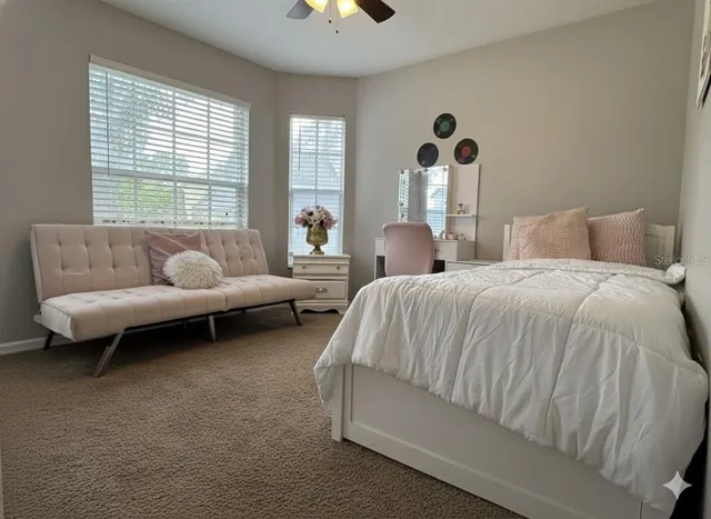 a bed sitting in a bedroom next to a window