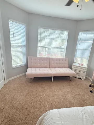 a bedroom with a bed and a couch