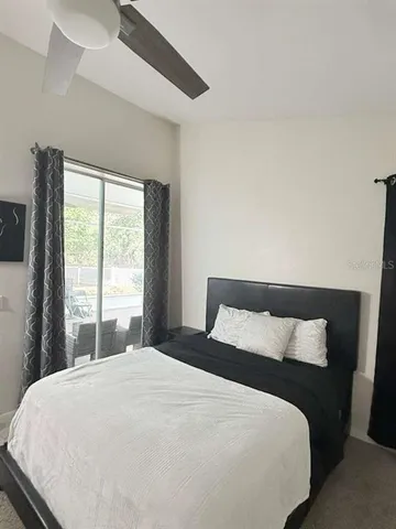 a view of a backyard with plants and a patio