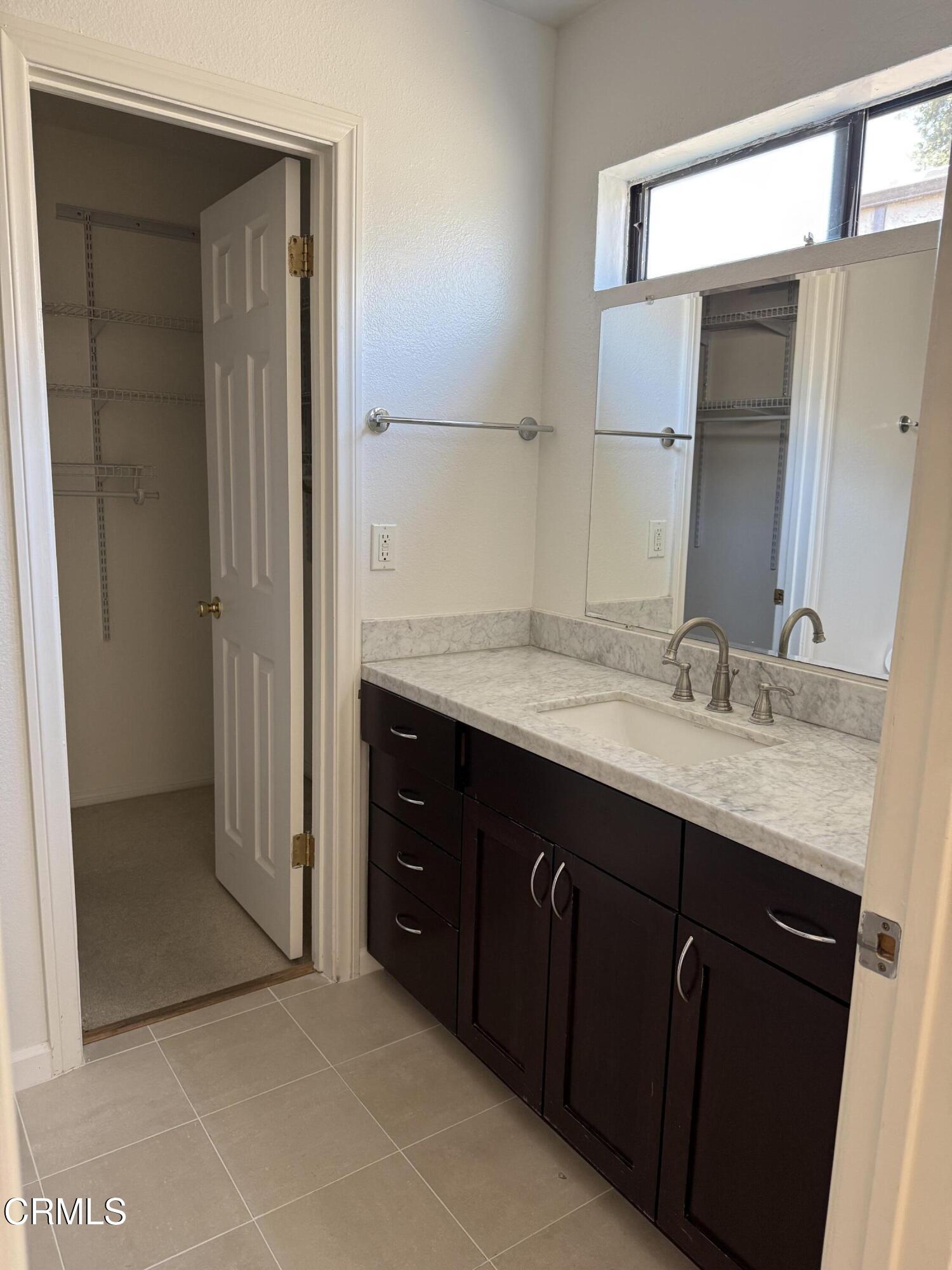 108 North Chapel Avenue, Unit 5 Alhambra, CA 91801 - Photo 15 of 30 a bathroom with a granite countertop sink and a mirror