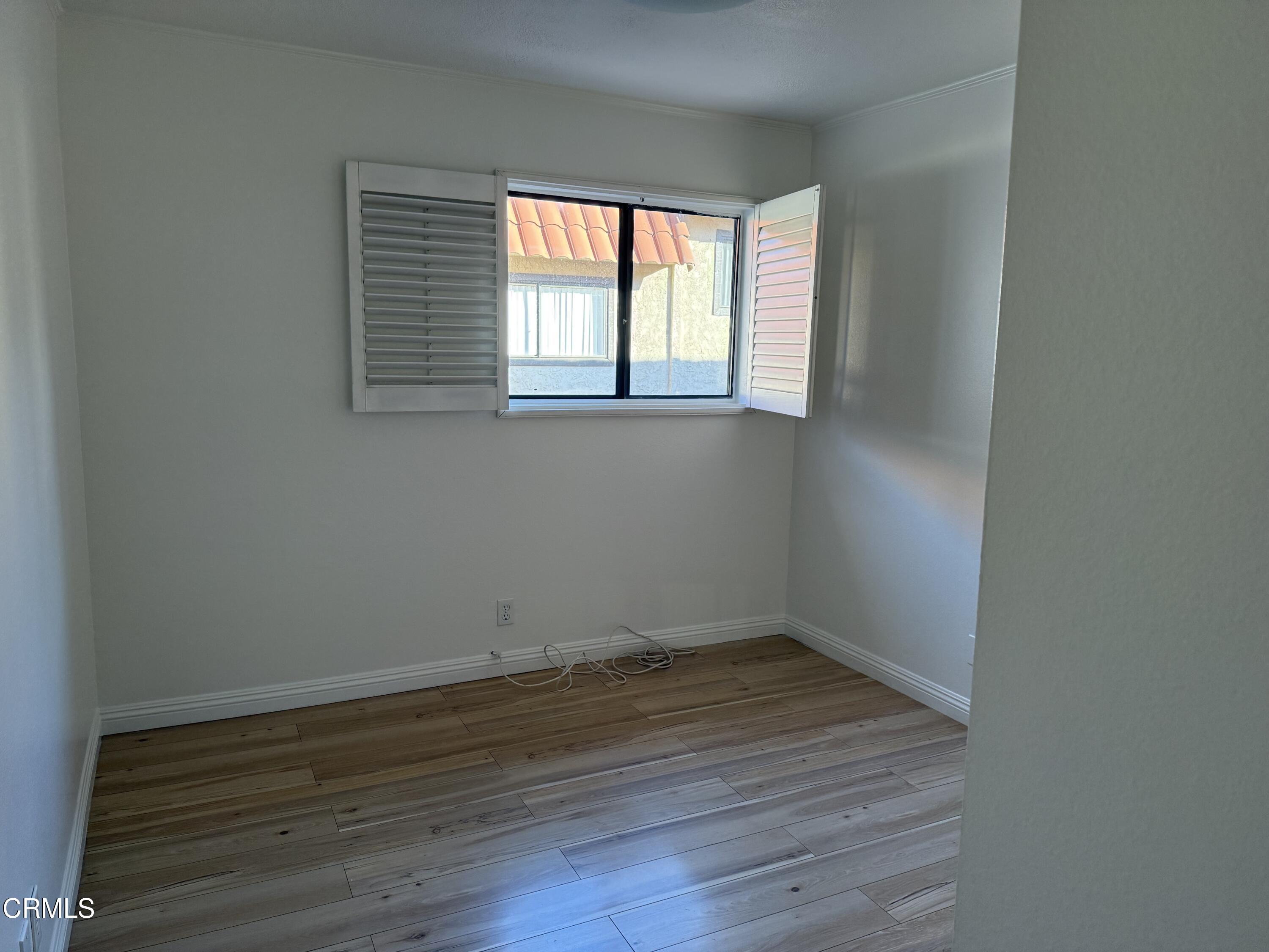 108 North Chapel Avenue, Unit 5 Alhambra, CA 91801 - Photo 18 of 30 an empty room with wooden floor and windows
