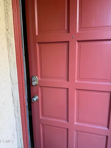 a view of empty room with wooden floor and fireplace
