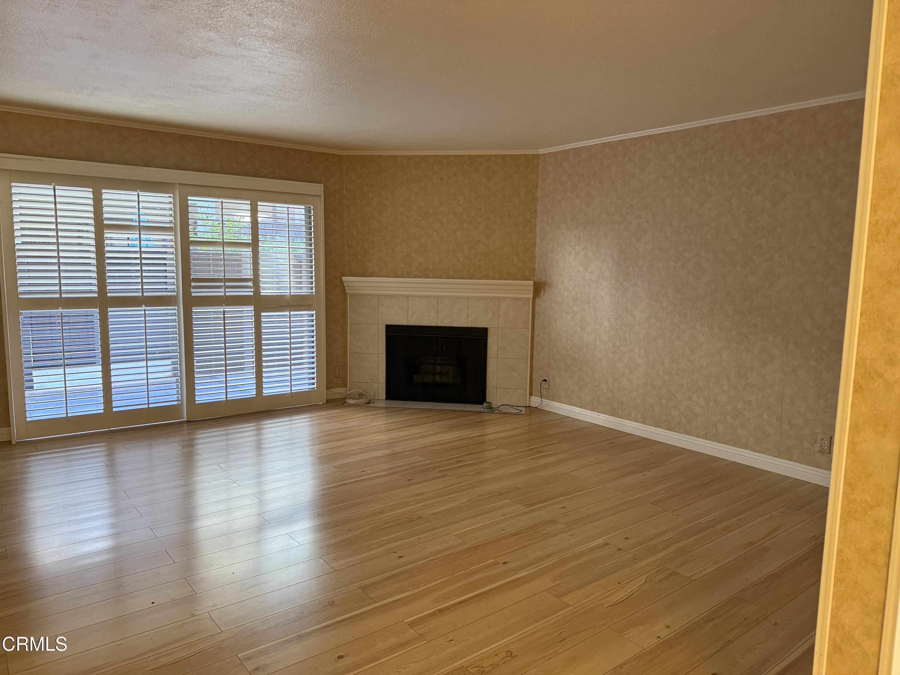 108 North Chapel Avenue, Unit 5 Alhambra, CA 91801 - Photo 5 of 30 a view of empty room with wooden floor and fireplace