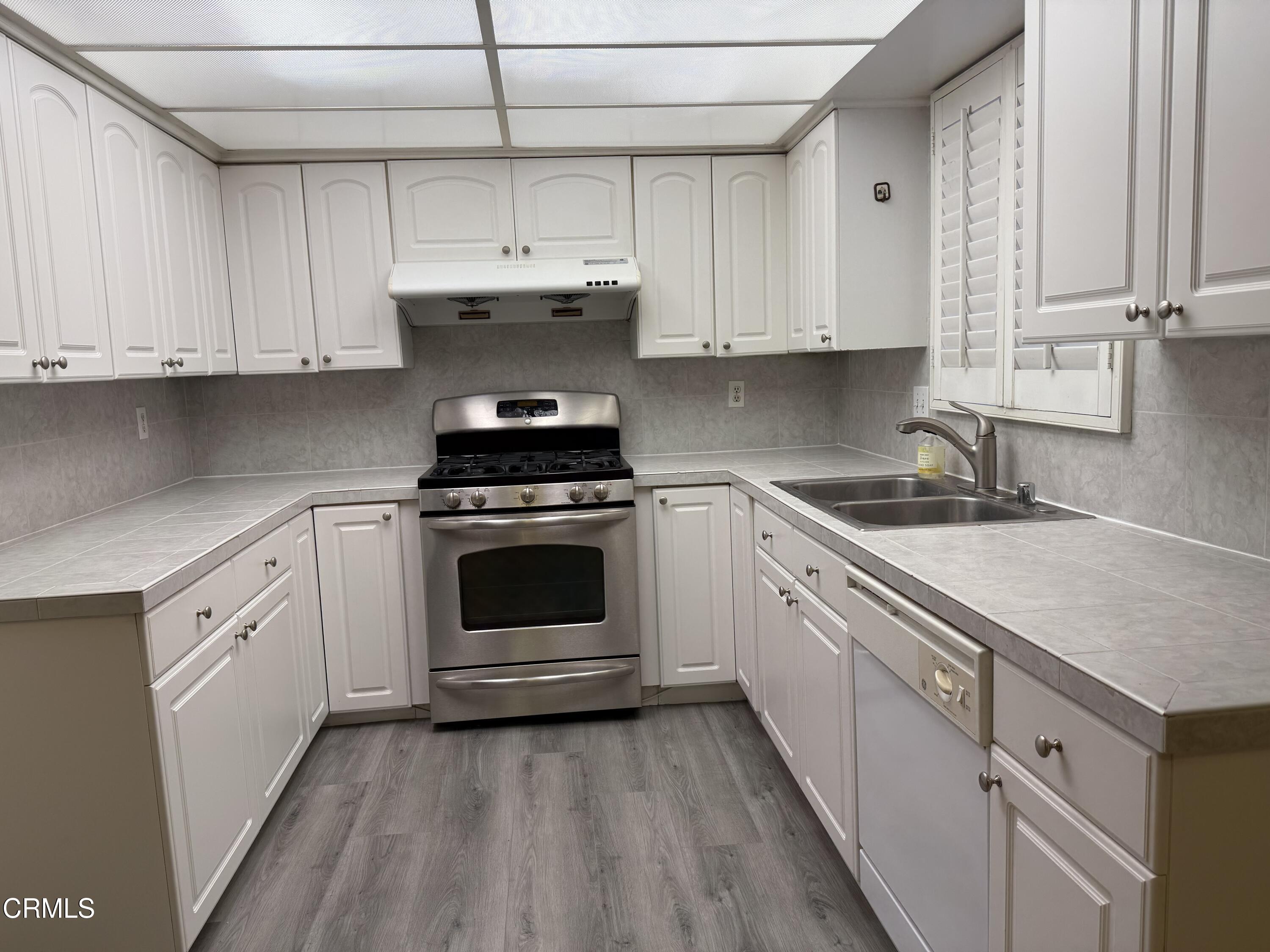 108 North Chapel Avenue, Unit 5 Alhambra, CA 91801 - Photo 8 of 30 a kitchen with cabinets stainless steel appliances and a sink