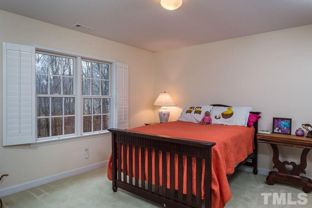 11905 Old Creedmoor Road Raleigh, NC 27613 - Photo 14 of 24 a bedroom with a bed and a window