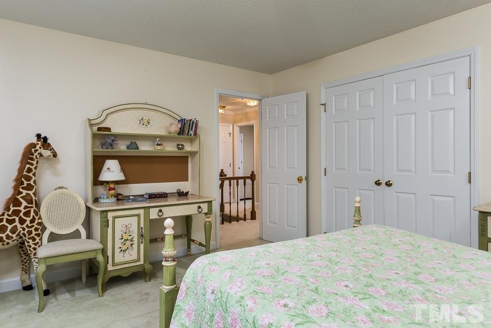 11905 Old Creedmoor Road Raleigh, NC 27613 - Photo 17 of 24 a bedroom with a bed and a chair
