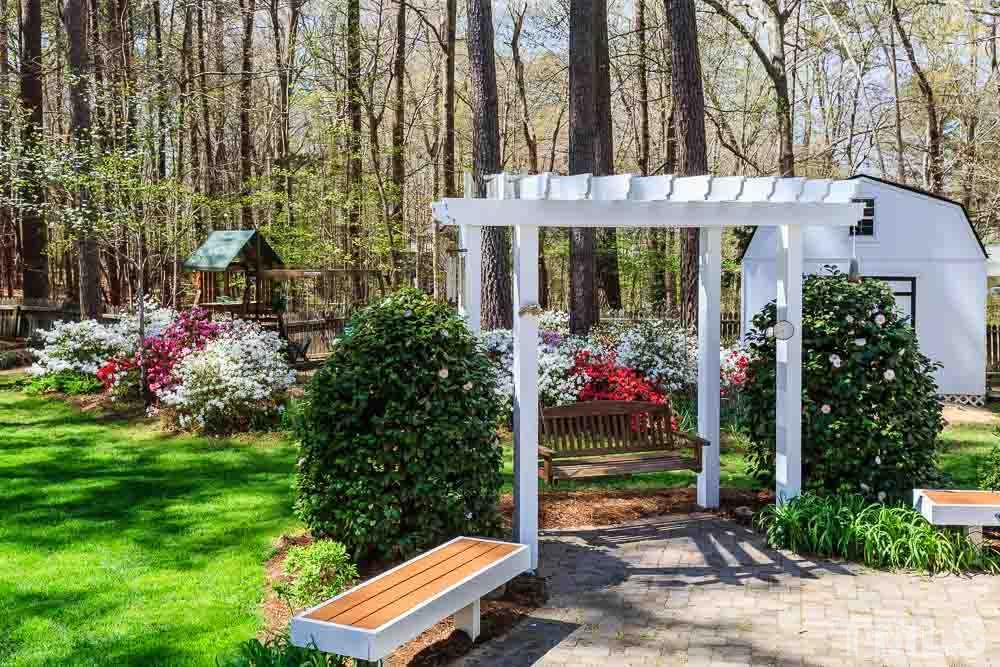 11905 Old Creedmoor Road Raleigh, NC 27613 - Photo 21 of 24 a front view of a building with a garden