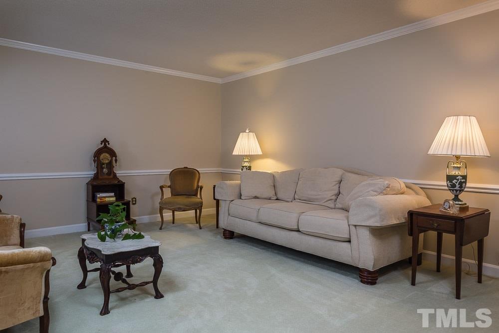 11905 Old Creedmoor Road Raleigh, NC 27613 - Photo 5 of 24 a living room with furniture and a lamp