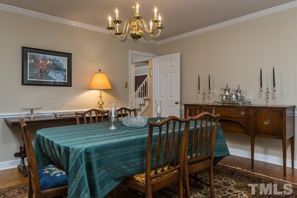 11905 Old Creedmoor Road Raleigh, NC 27613 - Photo 7 of 24 a view of a dining room with furniture and wooden floor