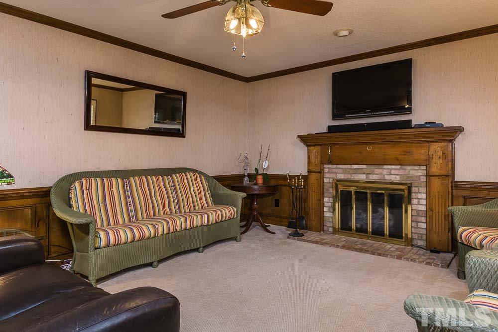 11905 Old Creedmoor Road Raleigh, NC 27613 - Photo 10 of 24 a living room with furniture and a fireplace