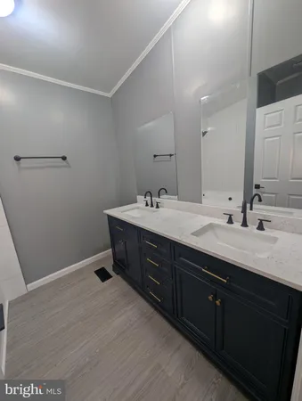 a bathroom with a double vanity sink and mirror