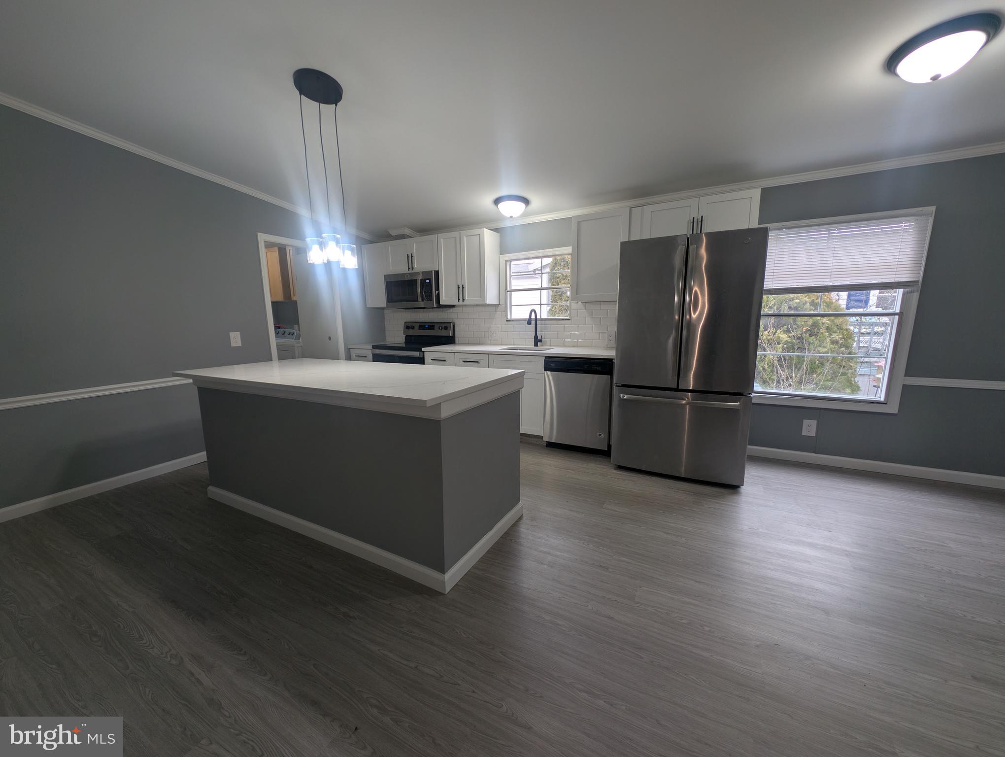 1926 Fletcher Road Aberdeen, MD 21001 - Photo 2 of 15 a kitchen with stainless steel appliances a refrigerator sink and wooden floor