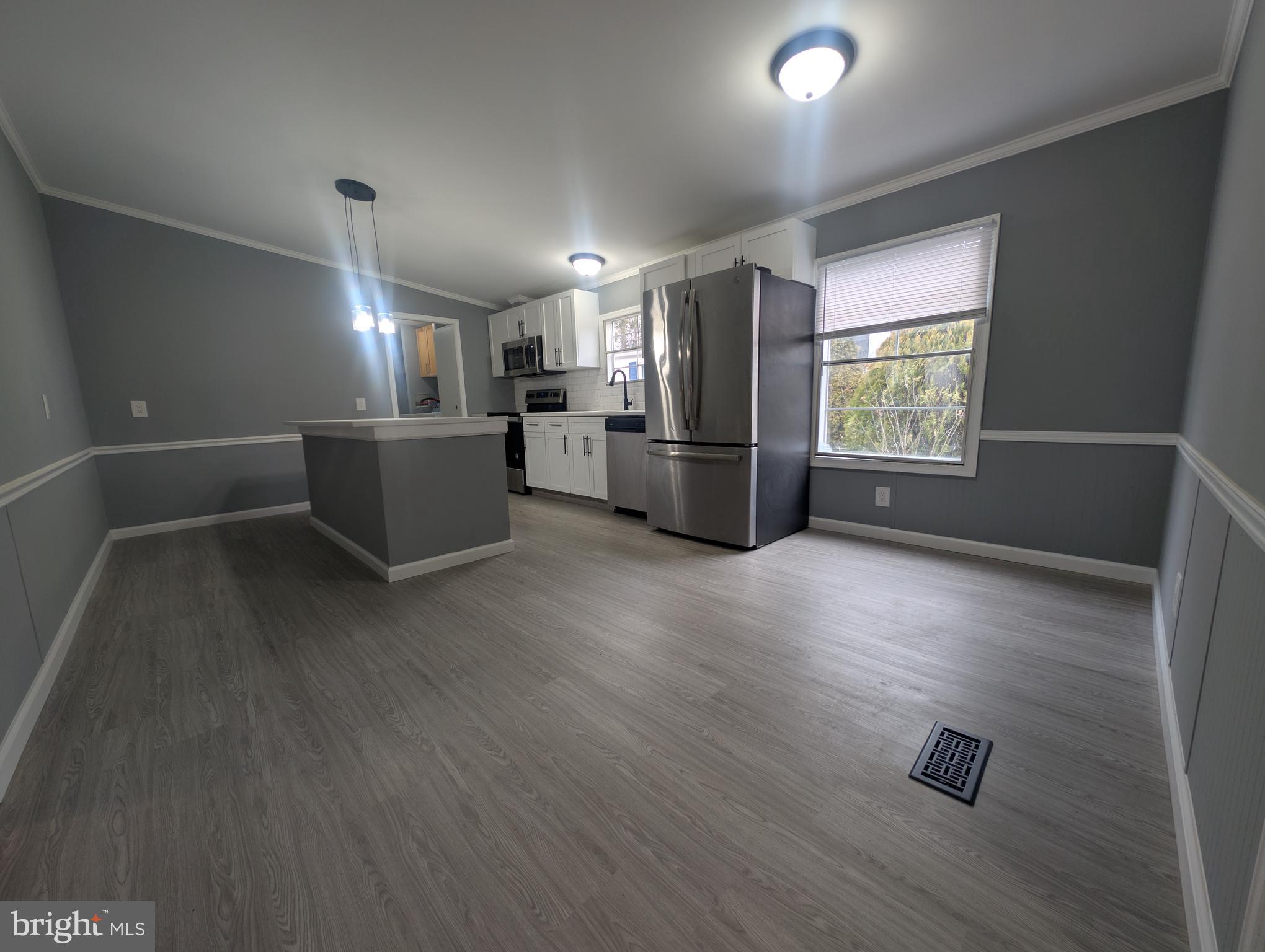 1926 Fletcher Road Aberdeen, MD 21001 - Photo 5 of 15 a kitchen with stainless steel appliances wooden floor and window